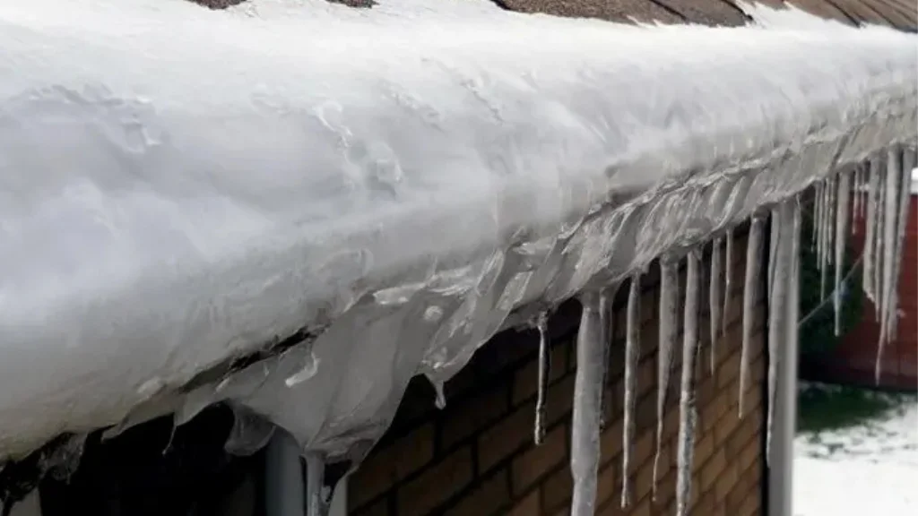 Icicles on snowy roof