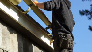 A man measuring the gutter size