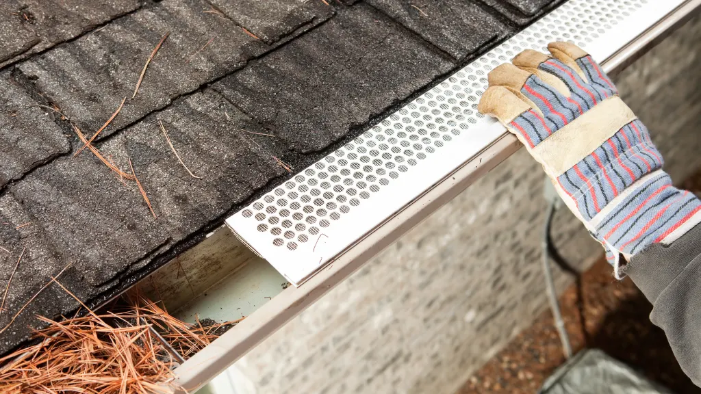Gutter guard installation to keep leaves and debris out of gutters